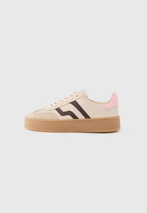 Beige sneakers with brown stripes, a pink heel accent, suede toe cap, and a gum sole. Features lace-up closure and rounded design.