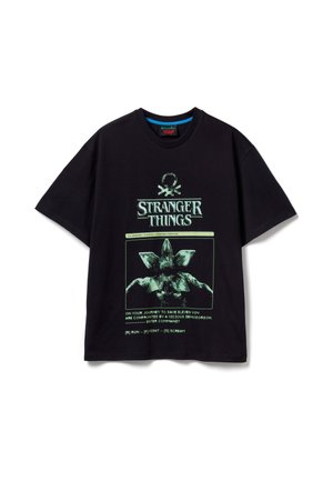 Schwarzes Baumwoll-T-Shirt mit grünem Grafikdruck eines Demogorgons und dem Schriftzug "Stranger Things". Kurze Ärmel und lockere Passform.