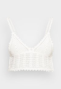 Bralette branco de crochet com alças ajustáveis, apresentando um padrão de diamante texturizado e bordas em formato de concha. Leve e suave.