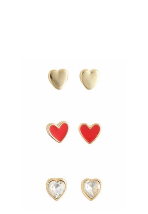 Set of three pairs of heart-shaped earrings: gold metal, red enamel, and crystal accents. Features smooth and shiny textures.