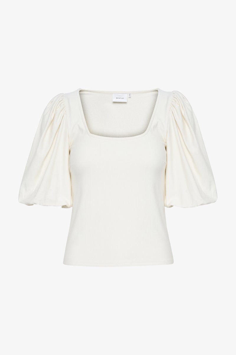 Top cu mâneci bufante, de culoare albă-crem, cu decolteu pătrat și material moale, elastic care se aderă la forma corpului.