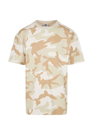 Beige kamouflage t-shirt i bomull. Har rund halsringning, korta ärmar och varierande nyanser av beige och kräm i ett lagerformat mönster.