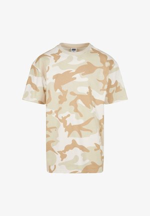 Beige álcázó póló pamutból. Kerek nyakkivágással, rövid ujakkal és különböző árnyalatú bézs és krémszínű rétegezett mintával rendelkezik.