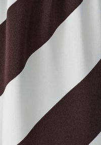 Brown and white striped fabric, featuring thick diagonal lines. The texture is smooth and woven, with a slight sheen.