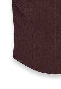 Burgundy structured top with a smooth texture, featuring seam detailing and a rounded hem. Made of fabric with a slightly matte finish.