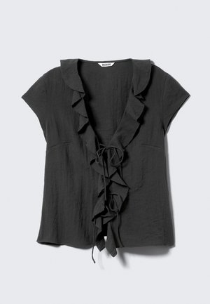 Dark gray blouse with short sleeves, ruffled collar and front, and a tie closure. Made of a textured, lightweight fabric.
