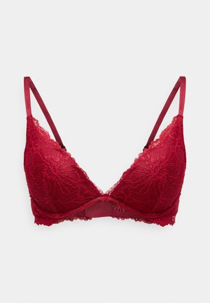 Red lace bra featuring a triangular shape, adjustable straps, floral pattern, and a smooth bandeau underband for support.