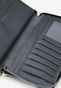 Black leather wallet interior with zip closure, featuring multiple card slots, a transparent ID section, and precise stitching details.