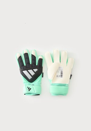 Paire de gants de gardien vert menthe avec dos rembourré noir et blanc, paumes blanches antidérapantes et sangles de poignet ajustables, posés à plat sur un fond clair.