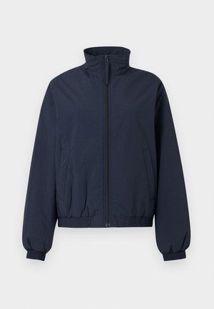 Veste bomber bleu marine avec col montant, fermeture éclair frontale, poignets élastiques, ceinture et deux poches latérales sur un fond clair uni.
