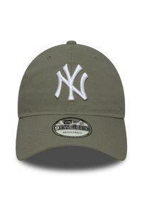 Olive green adjustable cap with a curved visor, featuring a white embroidered "NY" logo and a circular label detailing product specifications.