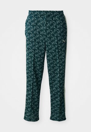 Green patterned pants featuring a repeated logo design, with an elastic waistband and a straight cut, displayed against a neutral background.