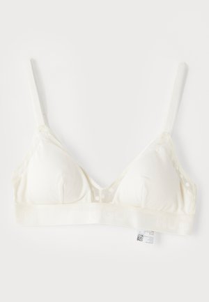 Soutien-gorge triangulaire blanc en tissu doux avec un panneau en résille à pois. Large bande portant l'inscription "HUGO" en bas. Bretelles ajustables.