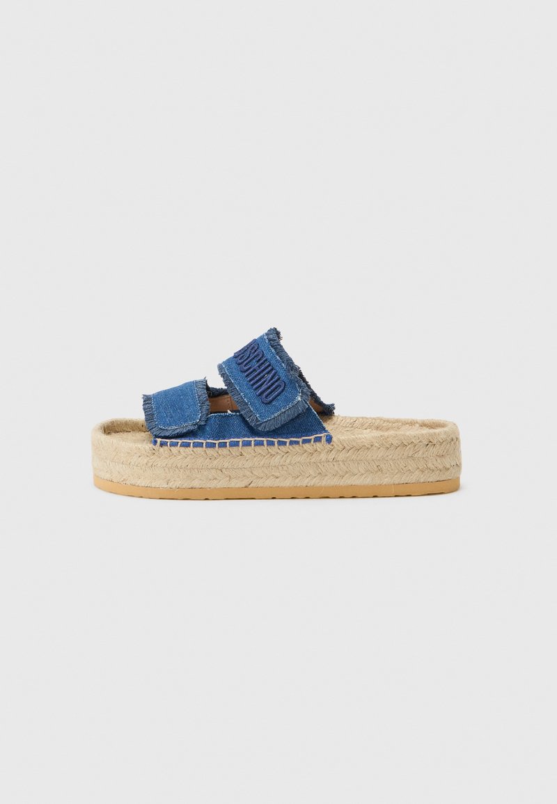Denim šlepetės su suplėšytais mėlynais diržais ir logotipu, turi austo jūroje platformos padu ir guminį pado sluoksnį, su kontrastinėmis siūlėmis.