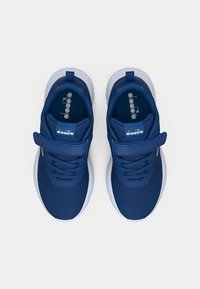 Baskets de sport bleu marine en mesh, avec une sangle sur le cou-de-pied et des semelles en caoutchouc blanc ; elles présentent des lacets et un détail de logo sur la languette.