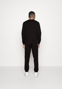 Lacoste Sport Träningsbyxor - black