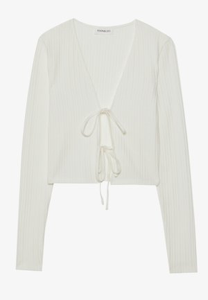 White ribbed crop top with long sleeves, deep V-neckline, and drawstring tie at the front. Soft texture with subtle patterning.