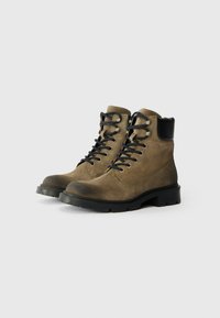 Botas de caminhada em suede castanho com detalhes em couro preto, bico redondo, ilhós de metal e atacadores pretos, com uma sola de borracha robusta.