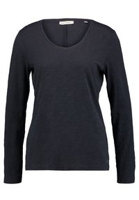 Långärmad skjorta i mörk marinblå, tillverkad av lätt, texturerad tyg med rundad halsringning och en subtil märkesetikett vid kragen.