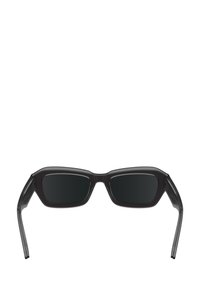 Ochelari de soare cu lentile negre dreptunghiulare. Ramă semi-transparentă de culoare neagră cu o textură subtilă. Urechi drepte cu o ușoară curbură la vârf.