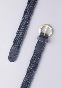 Woven leather belt in navy blue with a braided texture. Features a circular brass buckle and leather end with branding detail.