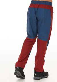 Miehen ulkoiluhousut sinisessä ja punaisessa, joissa on joustava vyötärönauha, vetoketjulliset taskut ja kevyt, teksturoitu kangas kestävyys.