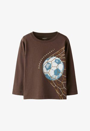 Brązowa koszulka dziecięca z długim rękawem, z niebiesko-białą piłką nożną uderzającą w siatkę oraz napisem „GOOOOOOOAAALI” wygiętym nad nią.