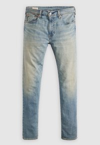 Jean en denim bleu clair avec un effet délavé, design à cinq poches, fermeture par bouton et fermeture éclair, coupe droite.