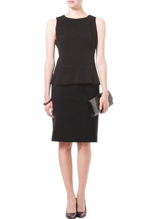 Robe peplum noire avec une jupe ajustée, tissu texturé, col rond et sans manches. Accompagnée d'une pochette noire.
