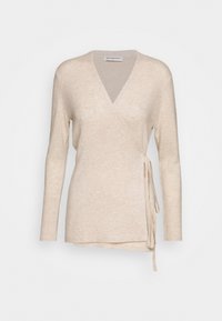 Beige omslagströja med V-ringning, långa ärmar och knytning på sidan. Mjuk textur med ribbade ärmmuddar och en något avslappnad passform.