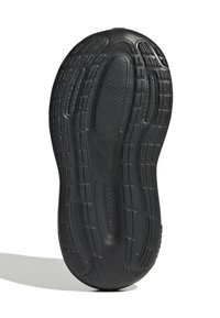 Svart gummisula med texturerade mönster och spår för grepp. Har ett slätt centralt område och rundad häl-design.