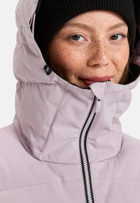 Light purple hooded jacket with a black zipper and textured detail. The hood is high-collared, and features a small logo tag.