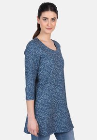 Blaue Tunika mit floralem Muster, Rundhalsausschnitt, dreiviertelärmel und lockerer Passform. Hergestellt aus leichtem, strukturiertem Stoff.