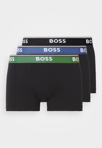 Pack of three black boxer shorts. Features elastic waistbands in black, blue, and green with "BOSS" printed in white. Soft cotton material.