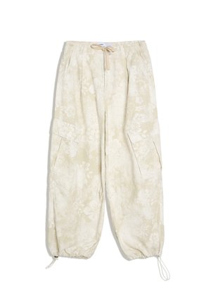 Beżowe spodnie cargo z kwiatowym wzorem, elastycznymi mankietami ze ściągaczami, bocznymi kieszeniami oraz paskiem ze sznurkiem.