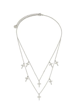 Silver layered necklace with three chains featuring six small, flat cross pendants. Smooth texture, minimal design, adjustable clasp at the back.