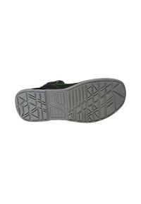 Scarpa sportiva nera e verde con suola in gomma testurizzata. Presenta scanalature e motivi per una maggiore trazione. La forma complessiva è arrotondata e aerodinamica.