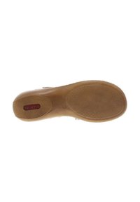 Semelle de sneaker en caoutchouc beige avec un motif de grip texturé. Présente une étiquette logo rouge. Forme courbée avec un talon plus large pour plus de stabilité.