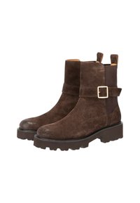 Stivali alla caviglia in suede marrone con suole spesse, pannelli elastici laterali e cinturini decorativi in oro.
