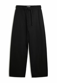 Schwarze weit geschnittene Sweatpants mit elastischem Bund, Kordelzug und Seitentaschen; aus weichem, strukturiertem Stoff hergestellt.