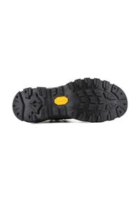 Suela de bota de senderismo de goma negra con profundas bandas de agarre, que presenta un prominente logo amarillo de Vibram y un diseño rugoso y texturizado para mayor tracción.