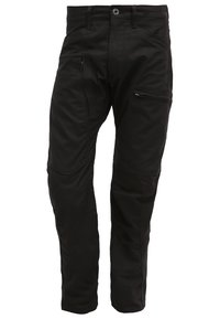 Svarta byxor i texturerat tyg, med en framficka med dragkedja, bälteshällor och en skräddarsydd passform med knädetaljer.