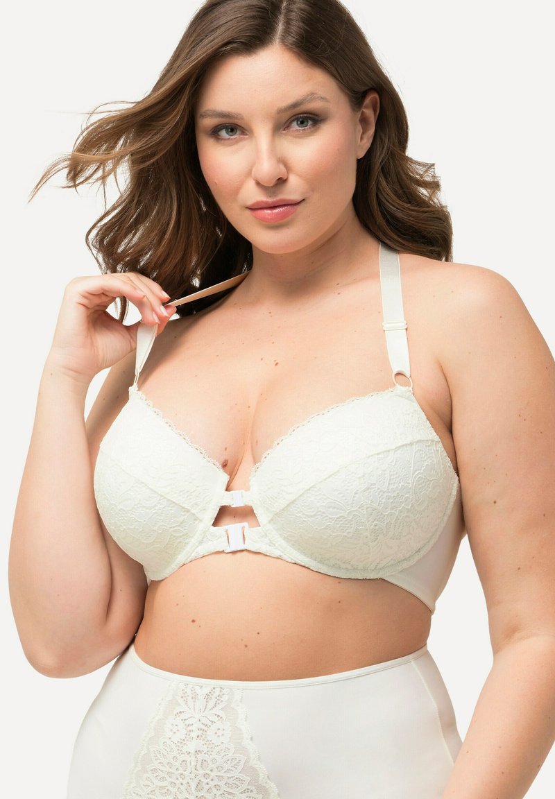 Witte kanten beha met een gladde stoffen basis, decoratieve uitsparing in het midden, verstelbare bandjes en delicate kantafwerking op de cups.