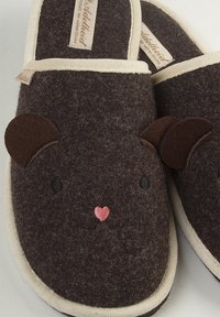 Brown felt slippers featuring a cute animal face design with dark brown ears, embroidered eyes, and a pink nose. Contrasting cream trim.