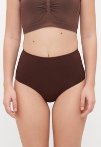 Des sous-vêtements marron taille haute fabriqués en tissu lisse avec une couleur unie et un design minimaliste, featuring des coutures discrètes et sans matériel visible.