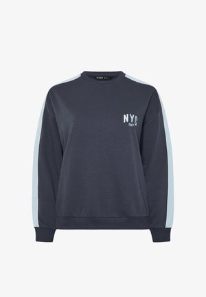 Laivastonsininen pitkähihainen collegepaita vaaleansinisin raidoin hihoissa ja "NYC 1987" -teksti vasemmassa rinnassa.