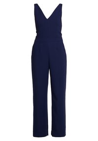 Mörkblå jumpsuit med djup V-ringning, ärmlös design, vida ben och sidofickor; tillverkad av ett slätt, strukturerat tyg.