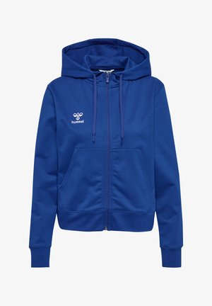 Niebieska bluza z zamkiem, wykonana z miękkiego materiału. Posiada kaptur ze sznurkiem, dwie przednie kieszenie, ściągacze u mankietów oraz białe logo na klatce piersiowej.