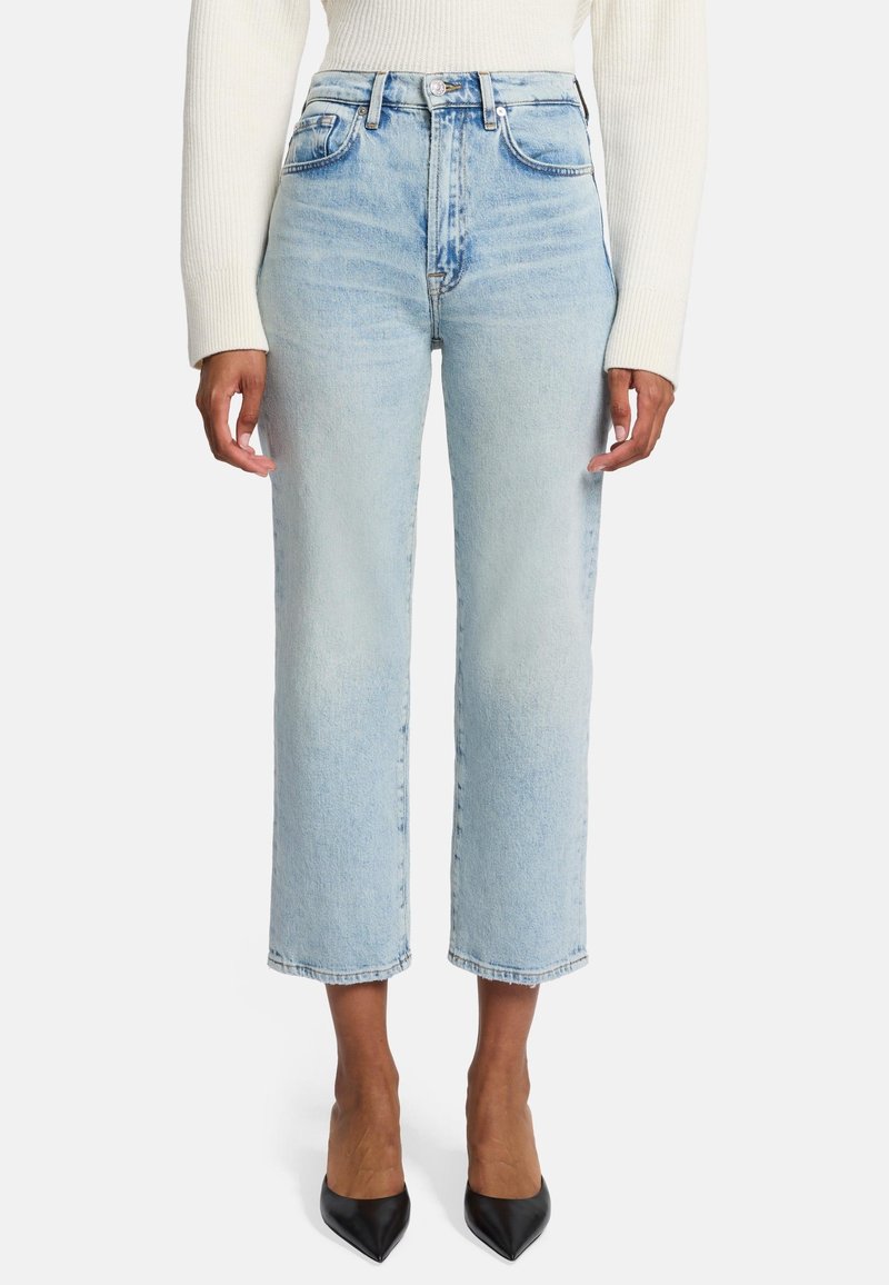 Jeans azzurri a vita alta con design a gamba dritta, cinque tasche e leggero effetto sbiadito. Abbinati a tacchi neri a punta.
