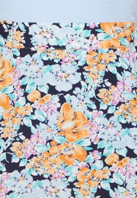 Tecido floral com grandes flores laranja e brancas, acompanhadas de folhas verde pastel, sobre um fundo azul-marinho; design em mistura de algodão curta.